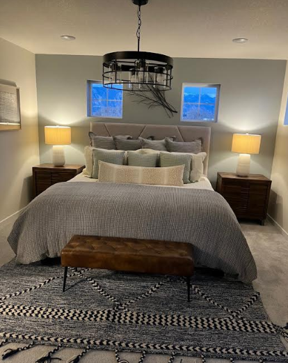 Serene bedroom with modern chandelier after VYP cleaning